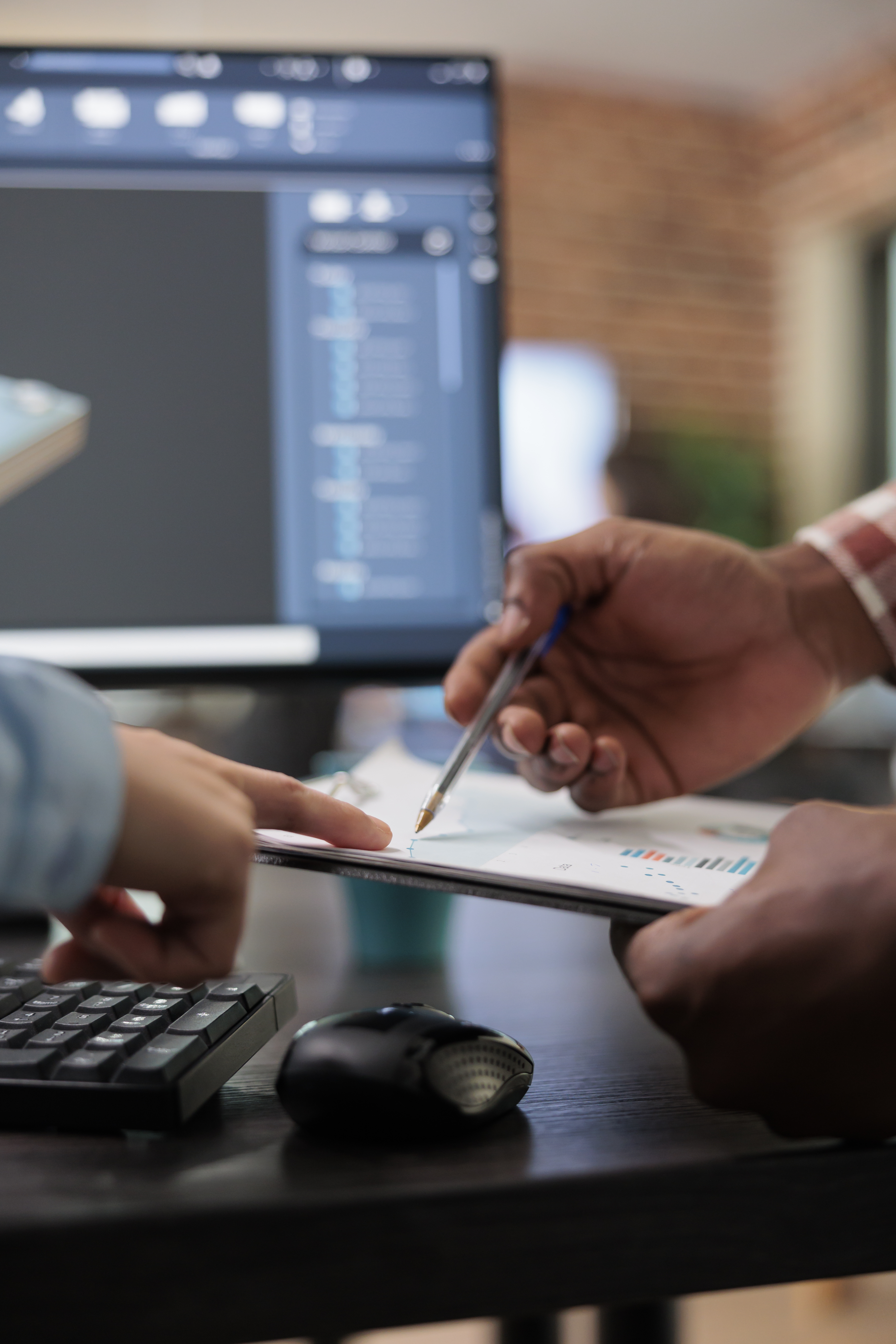 close-up-3d-digital-artists-reviewing-sketch-scene-plan-simulated-render-times-creative-industry-enthusiasts-with-cad-open-background-discussing-technical-issues-while-pointing-clipboard